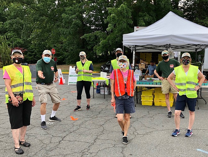 Volunteer team  manages Reston Farmers Market with Covid protocols.