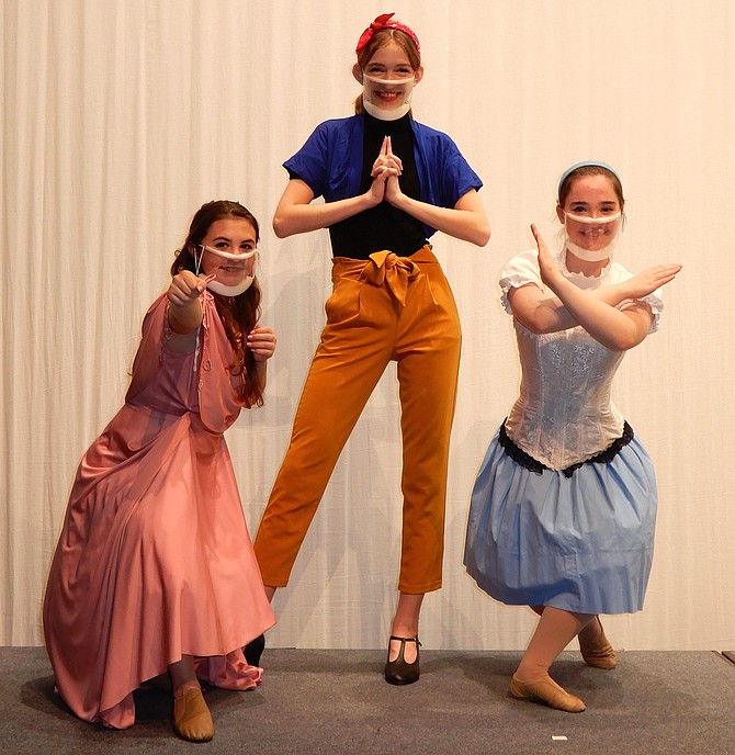 (From left) Disney princesses Josie Puckett, Caroline Jareb and Katie Wood strike a “Charlie’s Angels” pose for Centreville High’s musical, “Disenchanted.”