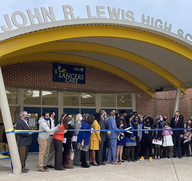 Students, staff, and officials prepare for ribbon cutting for John R. Lewis High School at Rededication Ceremony April 23.