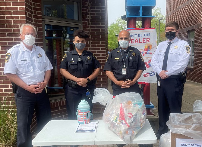 Sheriff Dana Lawhorne, Deputy Sheriff Angela Speight, Deputy Sheriff Victor Ignacio and Deputy Sheriff Sean Casey with some of the medicines collected April 24 at The Neighborhood Pharmacy as part of National Prescription Drug Take-Back Day.