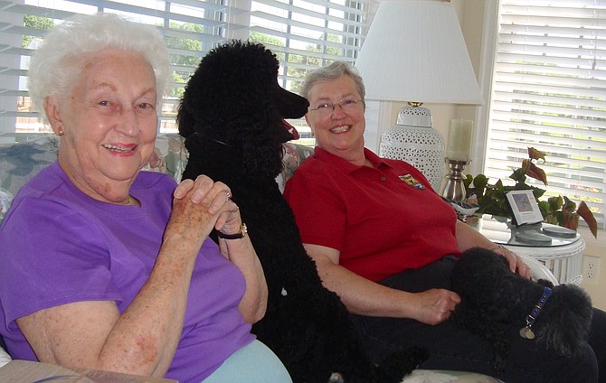 Alexandria resident Pam Matthes (right) with her mother, Pat. And in the middle, a big nosy poodle named Phoebe.