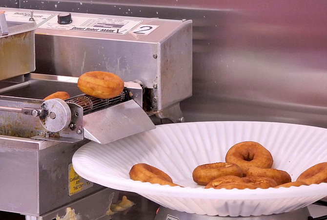 Duck Donuts fall into hot fat in front of your eyes and can be customized with your choice of coating, topping and drizzle.