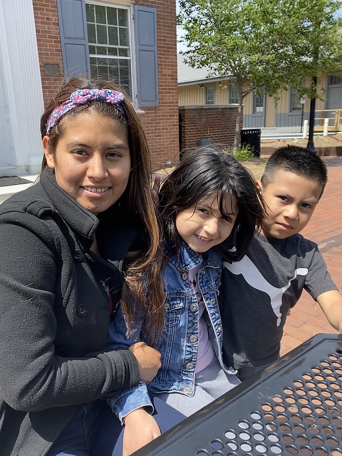 (From left) Kenci Santamaria of Herndon, her daughter, Jaritza Santamaria, 9, and son, Jefferson Jose, 6, enjoy Mother's Day on the Town Square in front of the Old Town Hall in Herndon. Jaritza Santamaria, 9: “Mom plays with me and takes me to the mall.”
Jefferson Jose, 6: “I like Mom's eggs.”