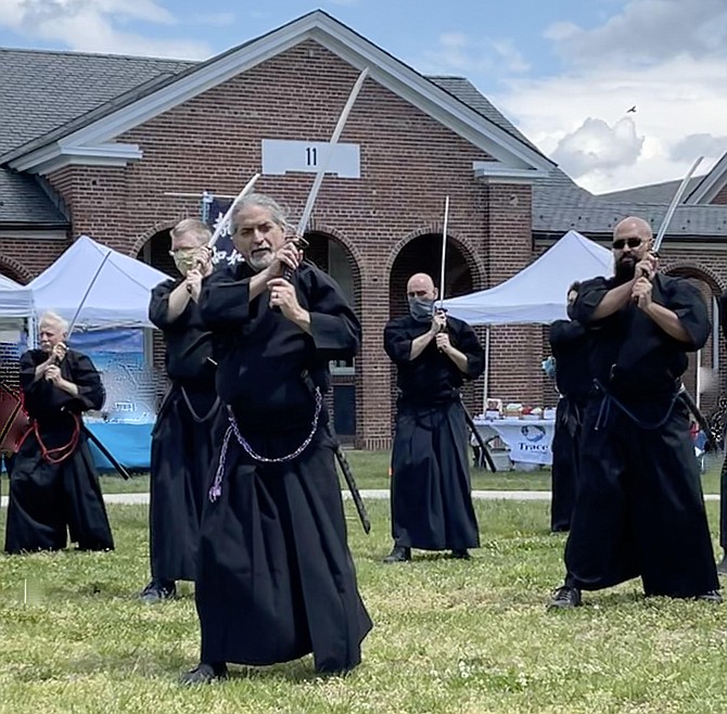 David Drawdy (center) leads group in sword moves to address enemies in front, behind, or on either side. Sword handlers (from left): Christopher Durr,  Patrick Bannister, Drawdy, David MConnell, Angel Lebron.