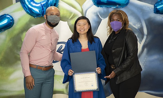 Marymount University’s  first Cultural Graduation Reception acknowledges the accomplishments of first-generation college graduates from underrepresented groups in an intimate and inclusive environment. Graduate Anna Moon, center, receives her Cultural Graduation certificate alongside Dean Brooke Berry, right, and Associate Director Tait Brooks.