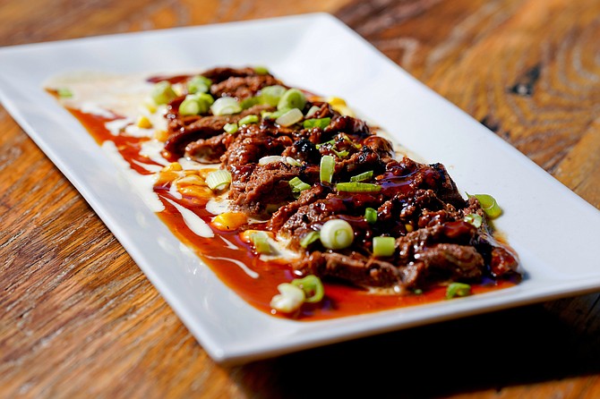 Coyote Grille’s appetizer of Carne con Crema de Maiz – Marinated steak on a bed of creamed corn drizzled with chipotlé bourbon sauce.