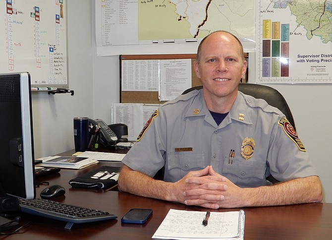 Police Capt. Jason Allegra at his desk at the Sully District Station.