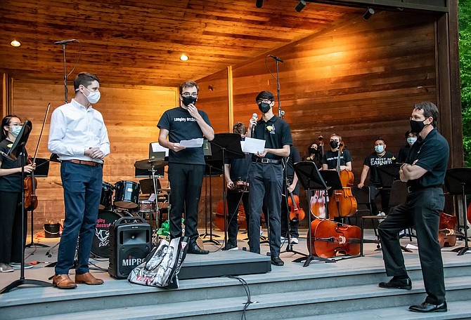 Senior cellists Misha Somogyi and Keon Parastaran present “A Tribute to Doc,” a self-composed piece dedicated to Langley Orchestra director Dr. McCormick (right).