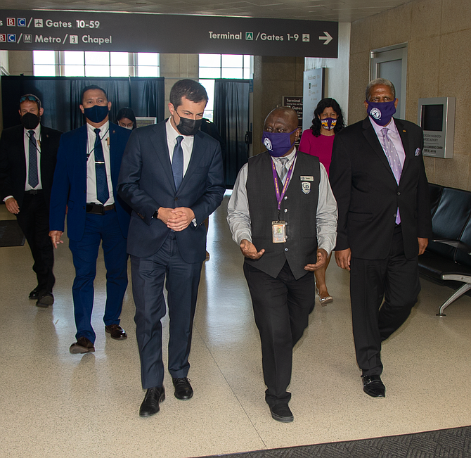 Kwaku Agyeman, an Alexandria resident,  talked to U.S. Secretary of Transportation Pete Buttigieg about airport workers’ fight for paid sick leave and health care from MWAA.