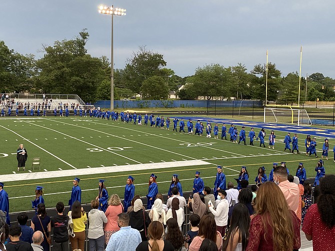 The class of 2021 takes a victory lap around the football field, becoming the first official graduates of John R. Lewis High School.