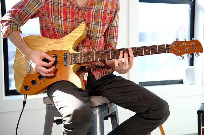 Aaron Maisler playing the modular guitar he invented and will soon produce at his Upperville factory.