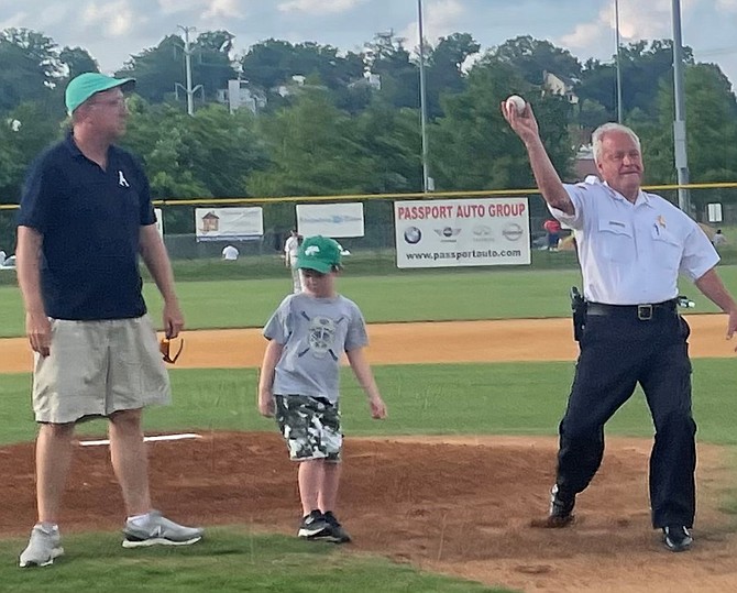 Sheriff Dana Lawhorne, right, throws out the ceremonial first pitch at the opening game for the Alexandria Aces June 8 at Frank Mann Field. Lawhorne is joined on the mound by his grandson Ryan Kaskela and Aces owner Frank Fannon.