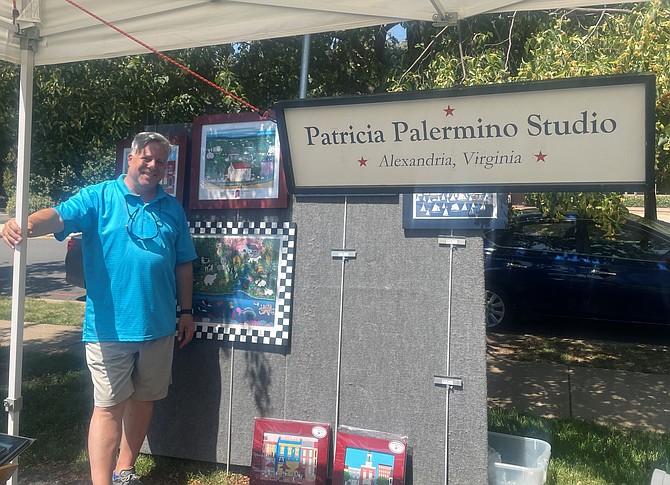 Jay Palermino with the artwork of his mother, Patricia Palermino, at the North Old Town Farmers Market June 6 in Montgomery Park.