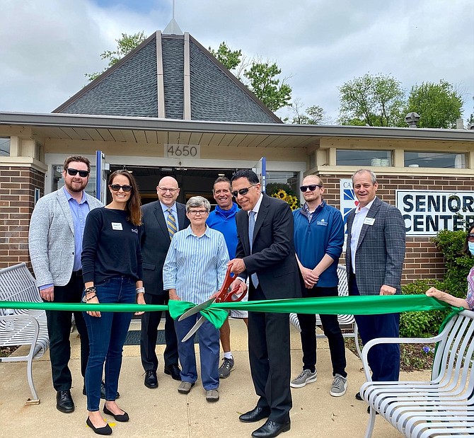 Ribbon cutting to celebrate the renovation of St. Martin de Porres Senior Center. Stephen Carattini, President and CEO of Catholic Charities, cuts the ribbon with officials from HomeAid Northern Virginia, Northfield Construction & Development, Trinity Group Construction and Catholic Charities.