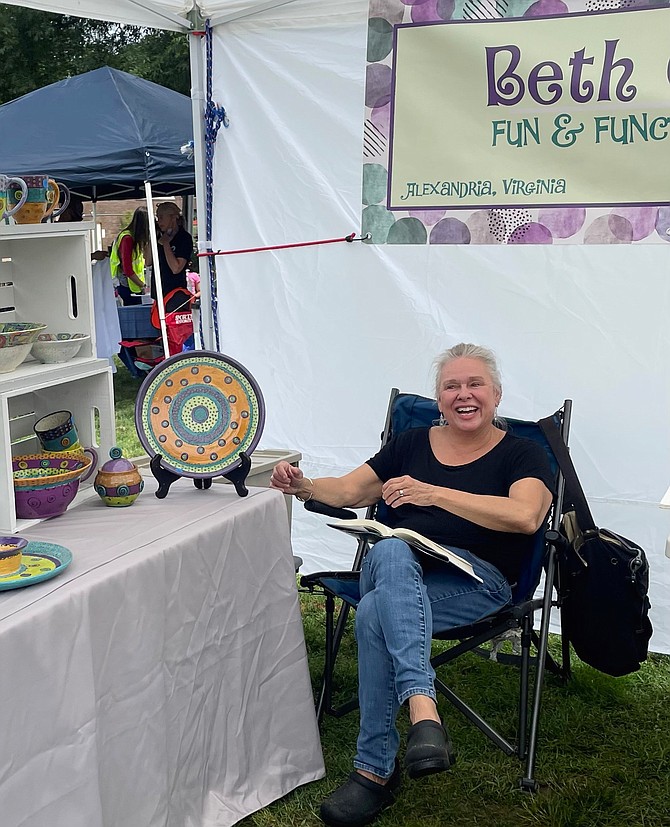 Ceramics artist Beth Coast relaxes during Volunteer Alexandria’s Old Town Arts and Crafts Fair June 12 at Waterfront Park.