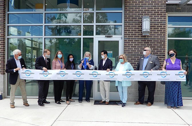 Dr. Candace Fugate prepares to cut the ribbon on TPG Pediatrics’ new office.