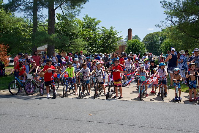Young bicyclists of River Falls, decked out in their patriotic finest, line up to start the annual 4th of July parade.