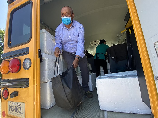 Coolers full of 7-day meal kits, planned by registered dietitian nutritionists and prepared daily by trained food service professionals pack a Fairfax County Public School bus for its Bus Route Meal Service, Summer 2021.