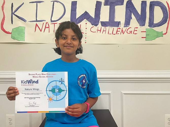 Holding her certificate, Pranamya Jindal celebrates her performance in the National KidWind Challenge.