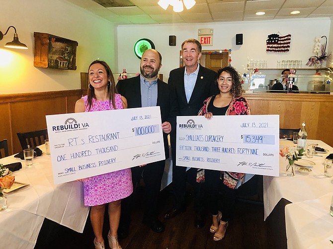 Gov. Ralph Northam presents checks from the Rebuild Virginia Economic Recovery Fund to George and Maria Christou, left, and Breanna Perez, right.
