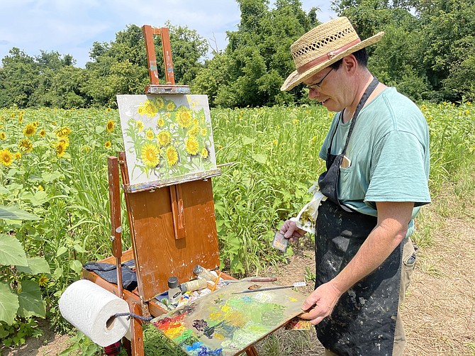 Poolesville artist James Vissari at his easel in a sunflower field at the end of Sycamore Landing.
https://www.facebook.com/james.vissari
https://jamesvissari.weebly.com/
“Over the years, I keep painting and drawing the sunflowers. Inspired by Vincent van Gogh, when the sunflowers are in bloom, it’s on! If sunflowers don’t inspire your inner joy, so sad for you. Even in the heat and humid sun beating down on me, the entire experience sets me free.”