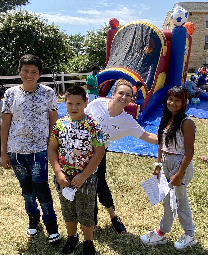 Jessica Gutierrez-Lugo (third from left) is a Community Organizer with Opportunity Neighborhoods. She is with youth at the Berkdale Apartments in the Town of Herndon, where in partnership with nonprofit Cornerstones, a Pfizer vaccine and Family Fun Day was held, bringing the immunization to the doorsteps of community members.