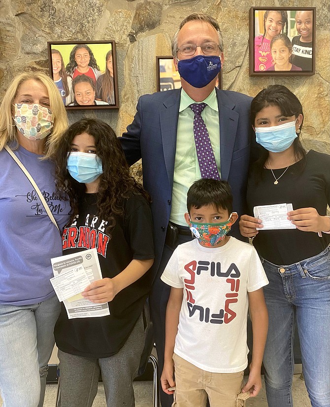 (From left) Renee Gorman; Kimberlin Jiminez,13; Scott Brabrand, Superintendent, Fairfax County Public Schools; Hansel Molina; and Jeimmy Molina take a congratulatory photo after Kimberlin and Jeimmy receive their first dose of the COVID-19 vaccine.