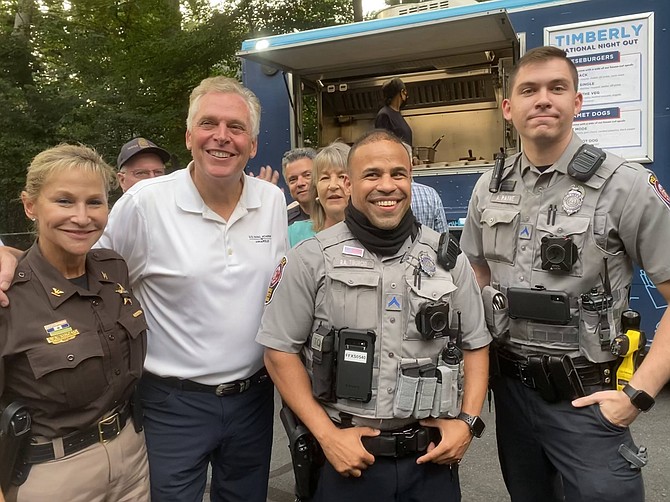 (From left) Fairfax County/Fairfax City Sheriff Stacey Ann Kincaid; former Virginia Governor (2014-2018) and Democratic nominee for Governor Terry McAuliffe; PFC Tiburcio; and PFC Payne take a few moments together at National Night Out 2021 held in the Timberly neighborhood of McLean. Organizer Leslie Mason is seen behind.