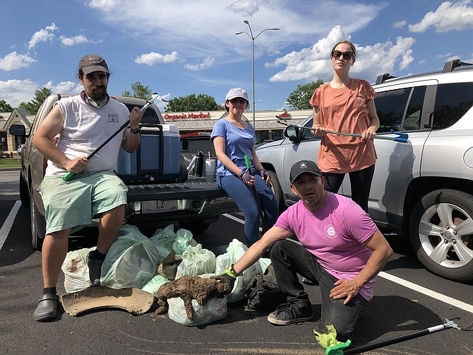 (From left) Employees of Mom's Organic Market in Herndon, Kendall Hobson of Herndon, Lea R. of Reston, Sevlin Roca of Ashburn, and  Kendall Scott of Leesburg pause at the truck in the cleanup of Sugarland Run. (Not pictured: Caton Fuller from Herndon).