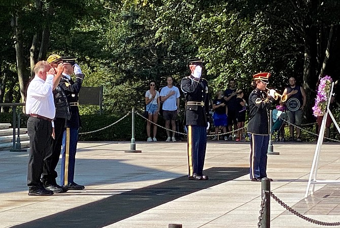 Warren Williamson, left, salutes during the playing of Taps following a wreath laying ceremony by members of the Tribute to Fallen Soldiers Northwest Motorcycle Ride at the Tomb of the Unknowns Aug. 8 at Arlington National Ceremony.
