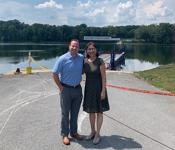 Councilmember Andrew Friedson and Del. Lily Qi stand in front of idled White’s Ferry at a meeting of local, state and federal representatives working to reopen the ferry.