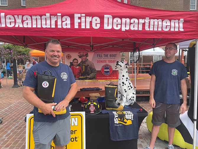 Firefighter Michael Kort, left, stands ready to collect donations Sept.4 at Market Square as part of the annual Fill the Boot campaign benefitting the Muscular Dystrophy Association.