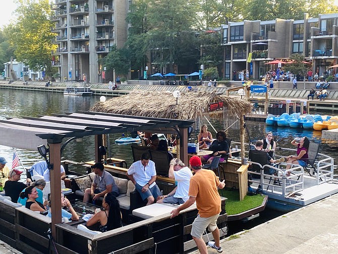 With multiple houseboats full of family and friends at Lake Anne's main dock, paddleboarders on SUPs head toward the remaining space to disembark and enjoy an evening of music.