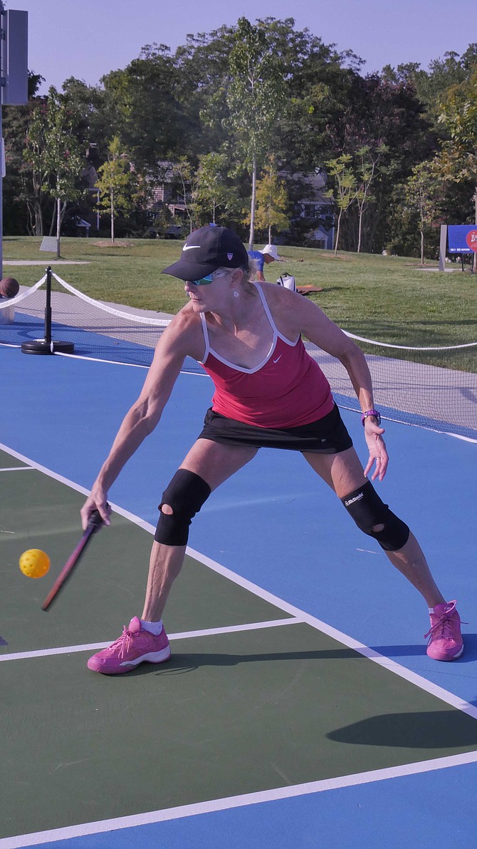Beth Baker returns a ball in the doubles pickleball competition where she plays with her partner Milly Stanges.