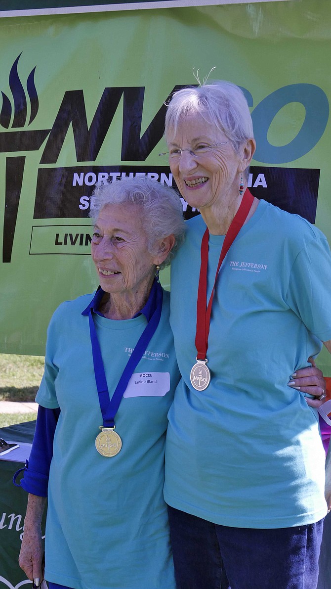 Janine Bland (left) takes gold and Barbara Scholtz the silver at Fairfax City Senior Center Green Acres on Saturday, Oct. 1. Both are residents at the Jefferson in Arlington.