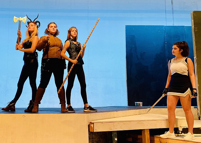 From left are Ella Ostlaund, Becca Marsh, Alyssa Dausch and Micaela O’Rourke in Chantilly High’s production of “She Kills Monsters: Young Adventurer’s Edition,” a dark comedy about the world of fantasy role-playing games..
