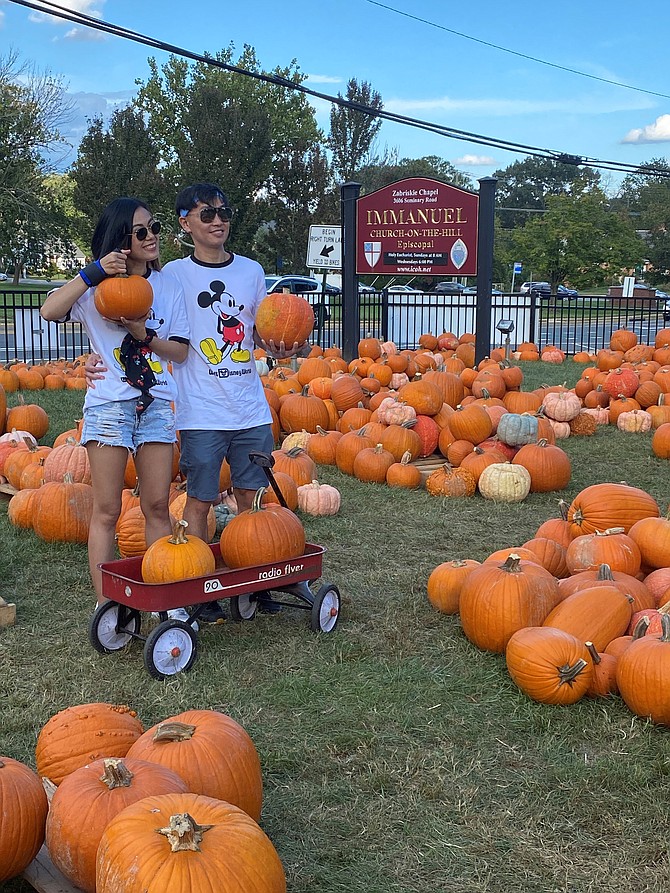 Chatchaya Pansiri and Warawat Prachongkarn hold up some of the pumpkins selected Oct. 4 at the Immanuel Church-on-the-Hill Pumpkin Patch.