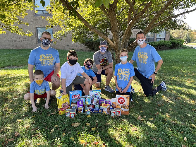 Scouts Robert, Owen, Quinn, and Luke with adult leaders Jeff, Scott, and Bryant from Pack 160 with food gathered at a Pack event for Scouting for Food in 2021 in Oak Hill.