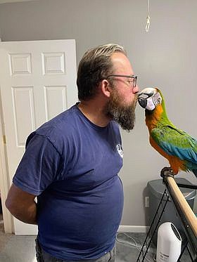 Holly the Macaw with her new owner. Holly was seized from unsuitable living conditions and AWLA won custody of her in court. “She was adopted by an awesome couple from Richmond.”