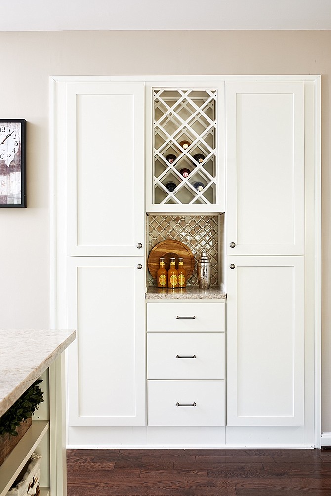 Creating a beverage station keeps guests out of the work space, but still part of the conversation, says Allie Mann of Case Architects & Remodelers.