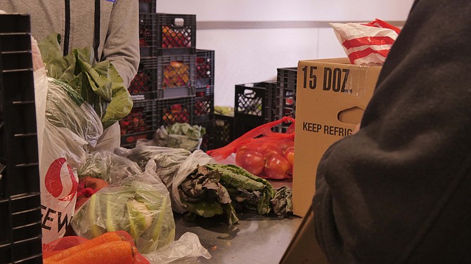 Randy Randall, an AFAC volunteer of 13 years, pushes a cart loaded high with fresh produce, which will provide plentiful choices for Thanksgiving at AFAC Nov. 15.
