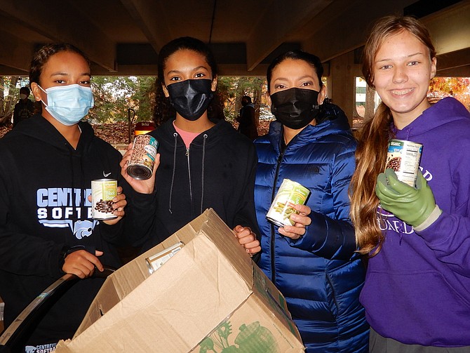 Lending a hand are (from left) sisters Aiko Conaway, Centreville High sophomore, and Mai Conaway, Union Mill Elementary sixth-grader; their mom, Noemy Conaway, and Chantilly junior Tara Sankner.
