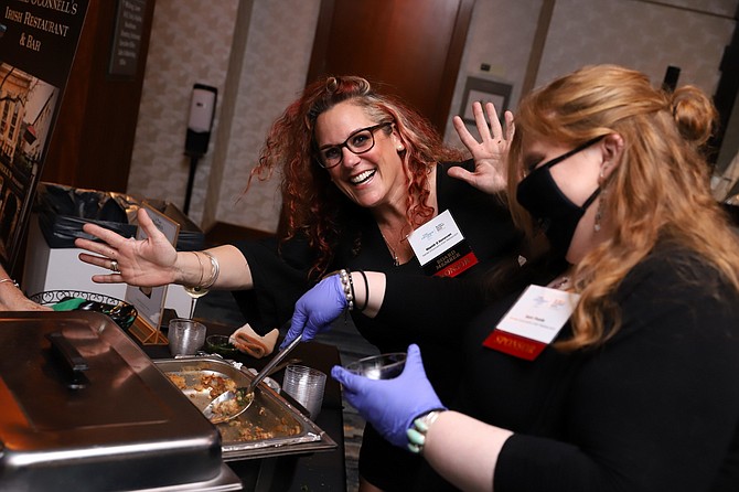 Niamh O’Donovan and Sam Poole are all smiles as Daniel O’Connell’s hands out Shepherd's Pie during the Best in Business Awards reception.