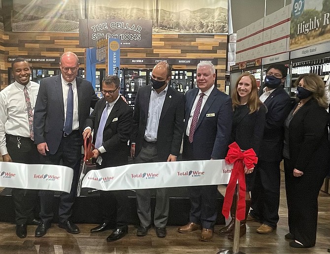 Chief Stores Officer Robert Hammack, left, watches store manager John West cut the ribbon to officially open the Total Wine & More at Potomac Yard Nov. 10. Also in attendance are Mayor Justin Wilson, Total Wine District Manager Michael Whatley, vice Mayor Elizabeth Bennett-Parker, and council members Canek Aguirre and Amy Jackson.