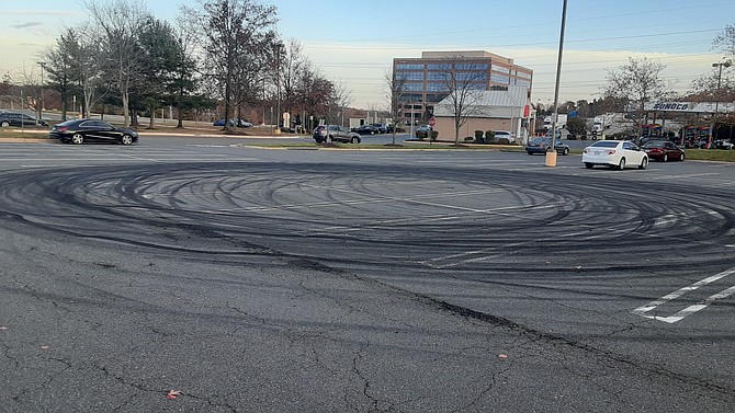 A week later, in the Kingstowne parking lot, the circle of tire marks are a reminder of the street racing incident.
