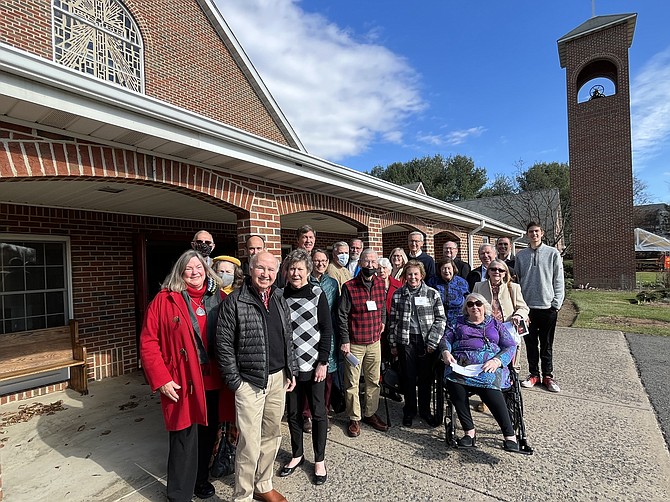 Congregation members and Rev. Henry J. (Hank) Langknecht, who serves as pastor of Christ the King Lutheran Church in Great Falls gather in front of the church doors.