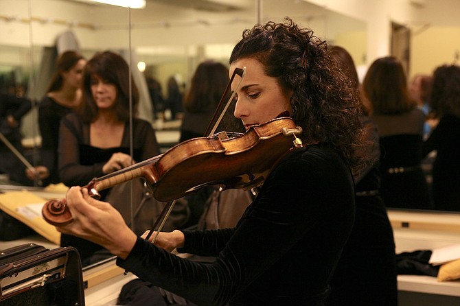 Julie Gigante warms up on the violin prior to a Los Angeles Chamber Orchestra concert at the Alex Theatre in Glendale, California. Photo Courtesy of Los Angeles Chamber Orchestra