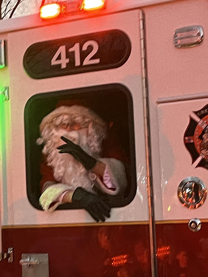 Santa waves from the window of Engine 412, Fairfax County Fire and Rescue Station #12, Great Falls Volunteer Fire Department.