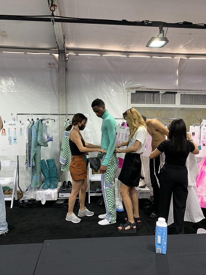 The primping backstage is all part of the process at the Louis Vuitton fashion show in Miami.