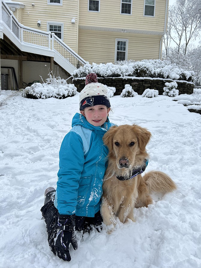 Emma Ryan and her golden retriever, Sadie, in the first snowfall of 2022